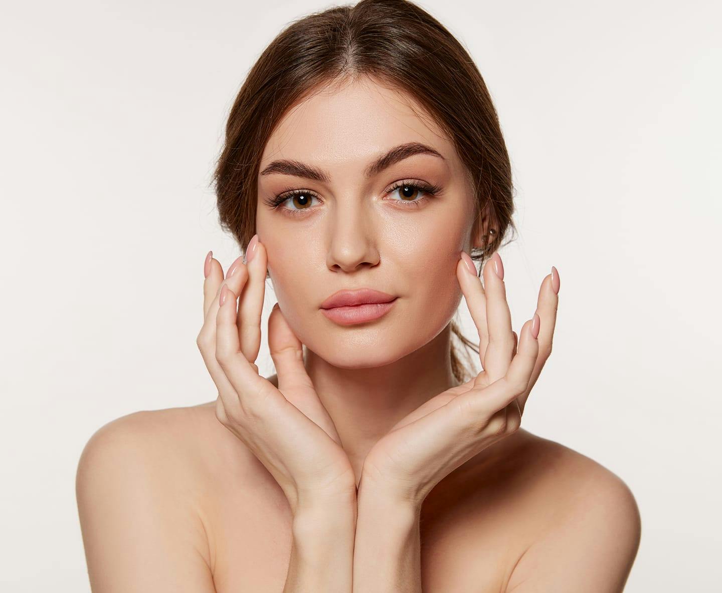 woman touching her cheek bones