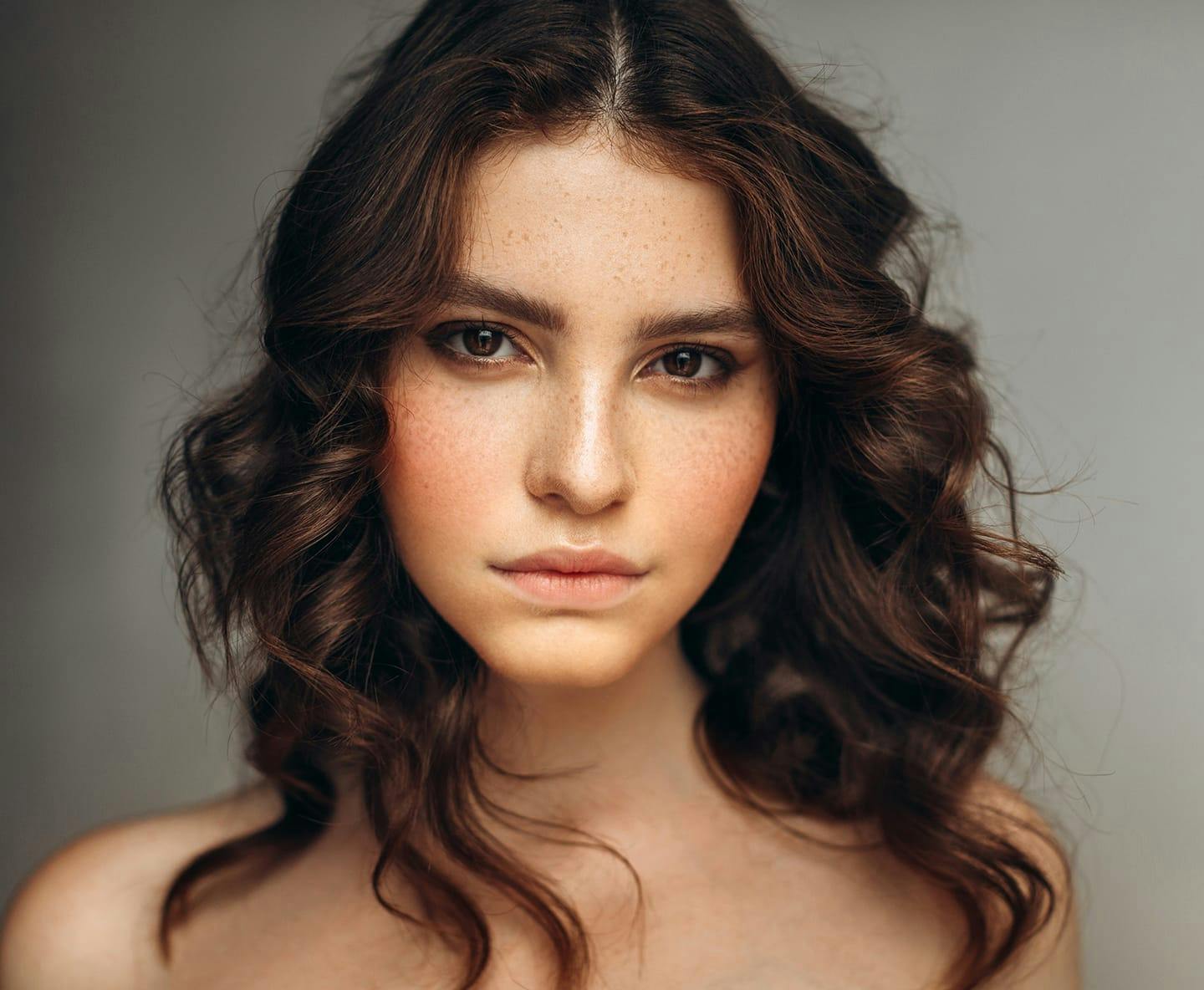 woman with wavy hair looking forward