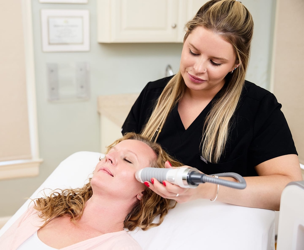 patient with microneedling tool on her face