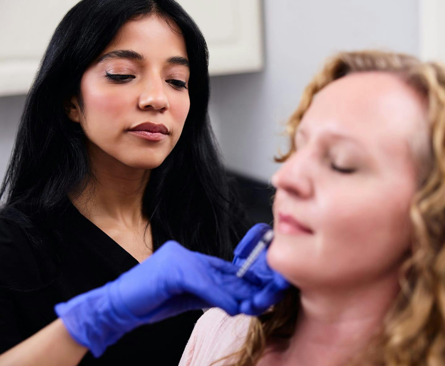 Nurse injecting patient's face