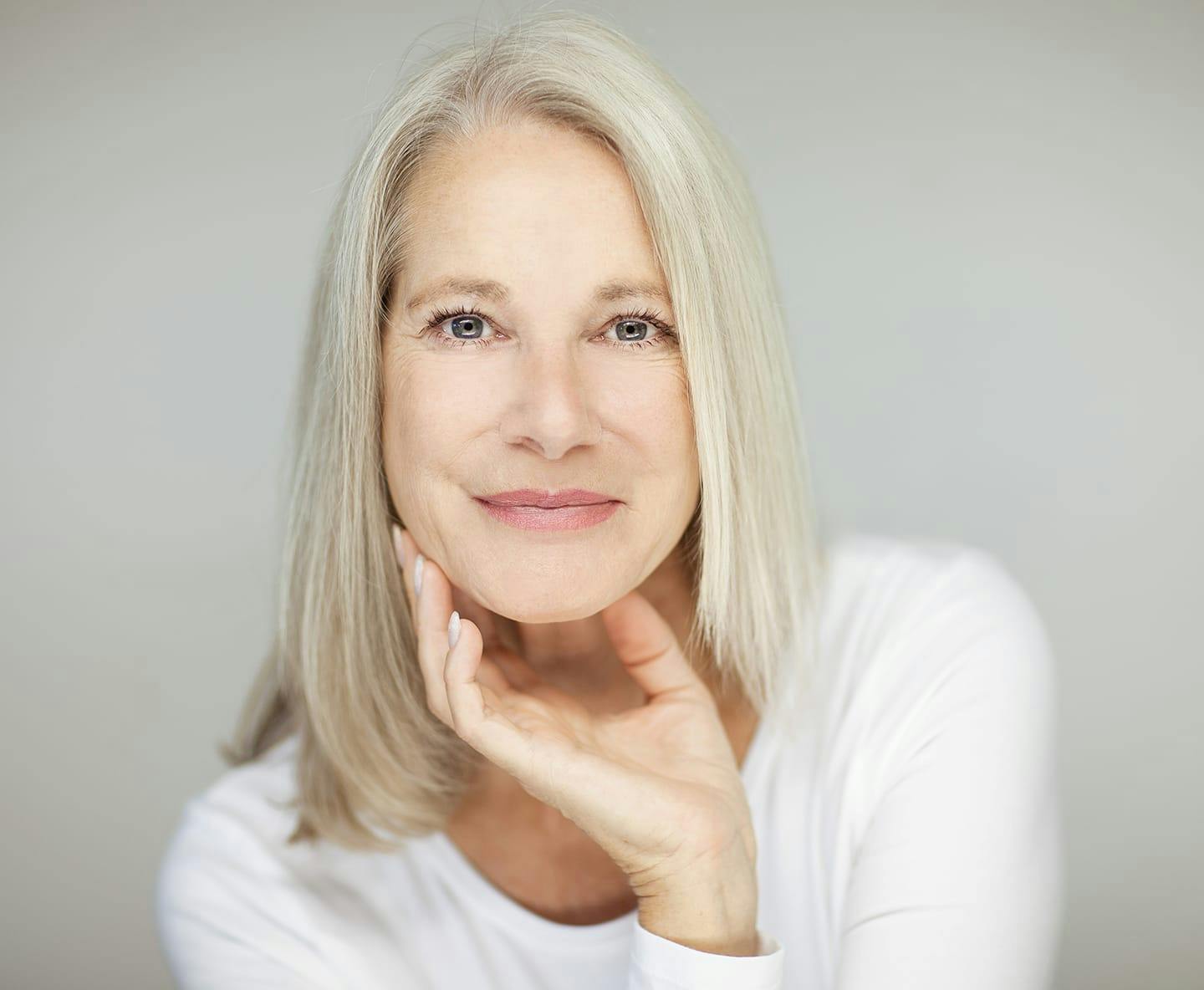 older woman in white long sleeve shirt