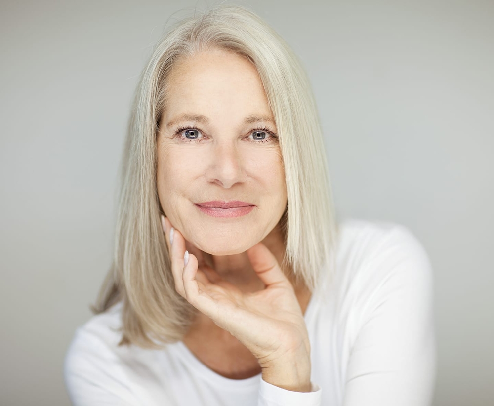 older woman in white long sleeve shirt