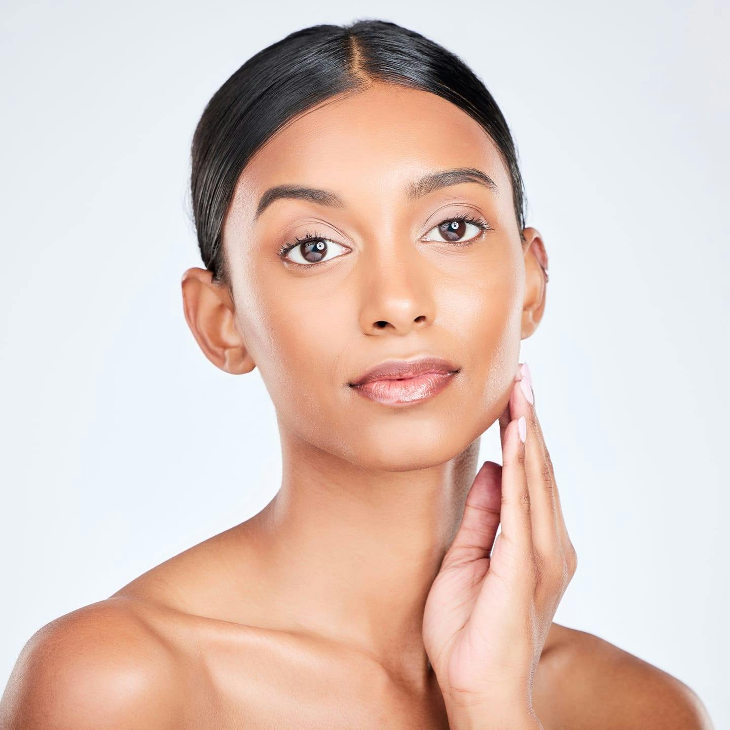 woman looking forward touching her jaw