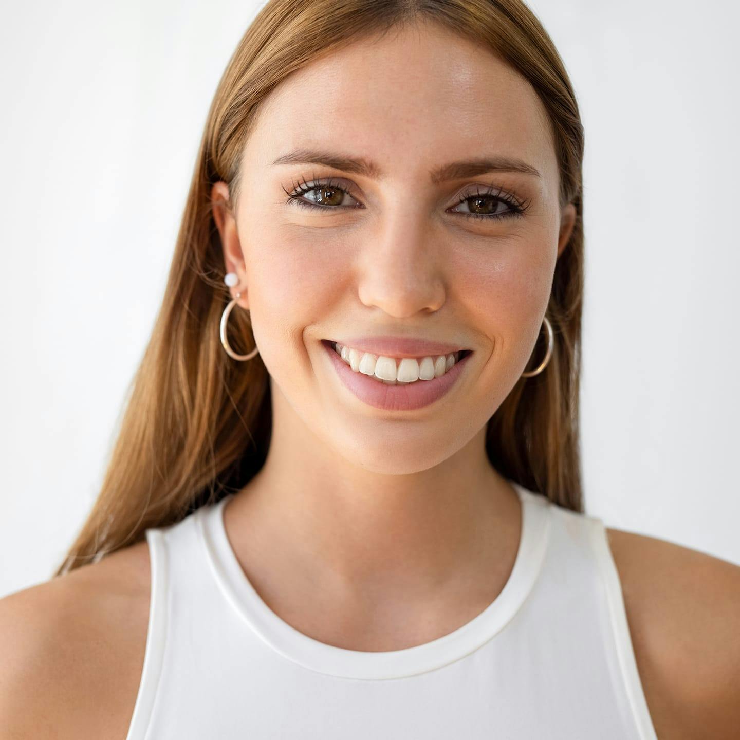 woman with red hair looking forward and smiling