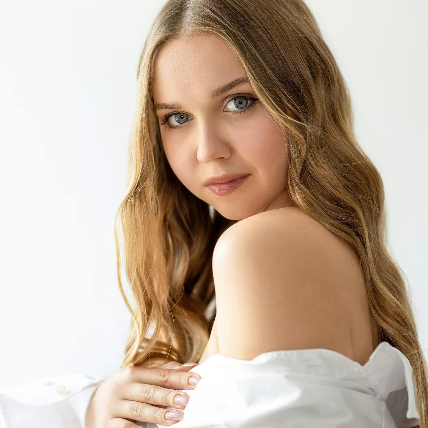 woman with long hair in big collared shirt hanging off her shoulders