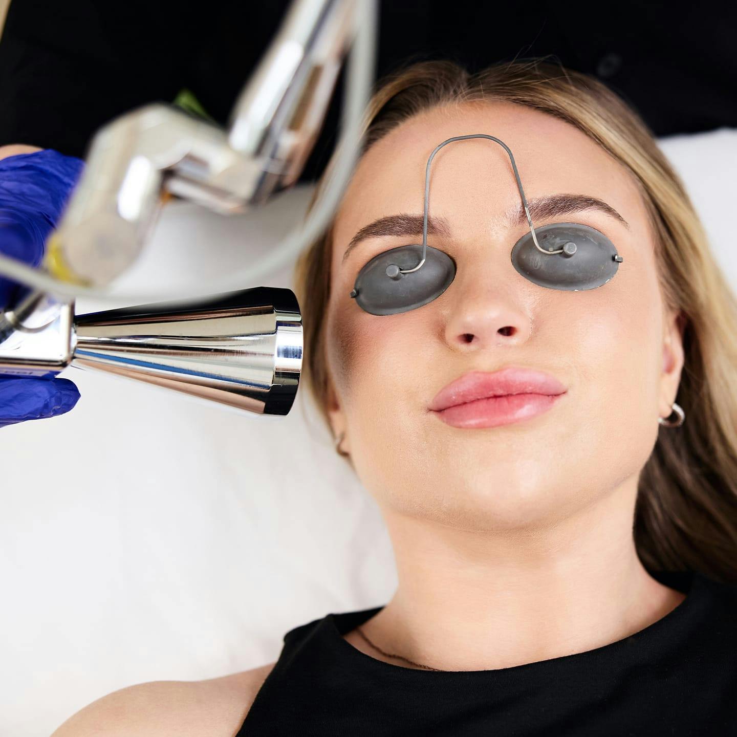 patient with eyes covered with machine near her face