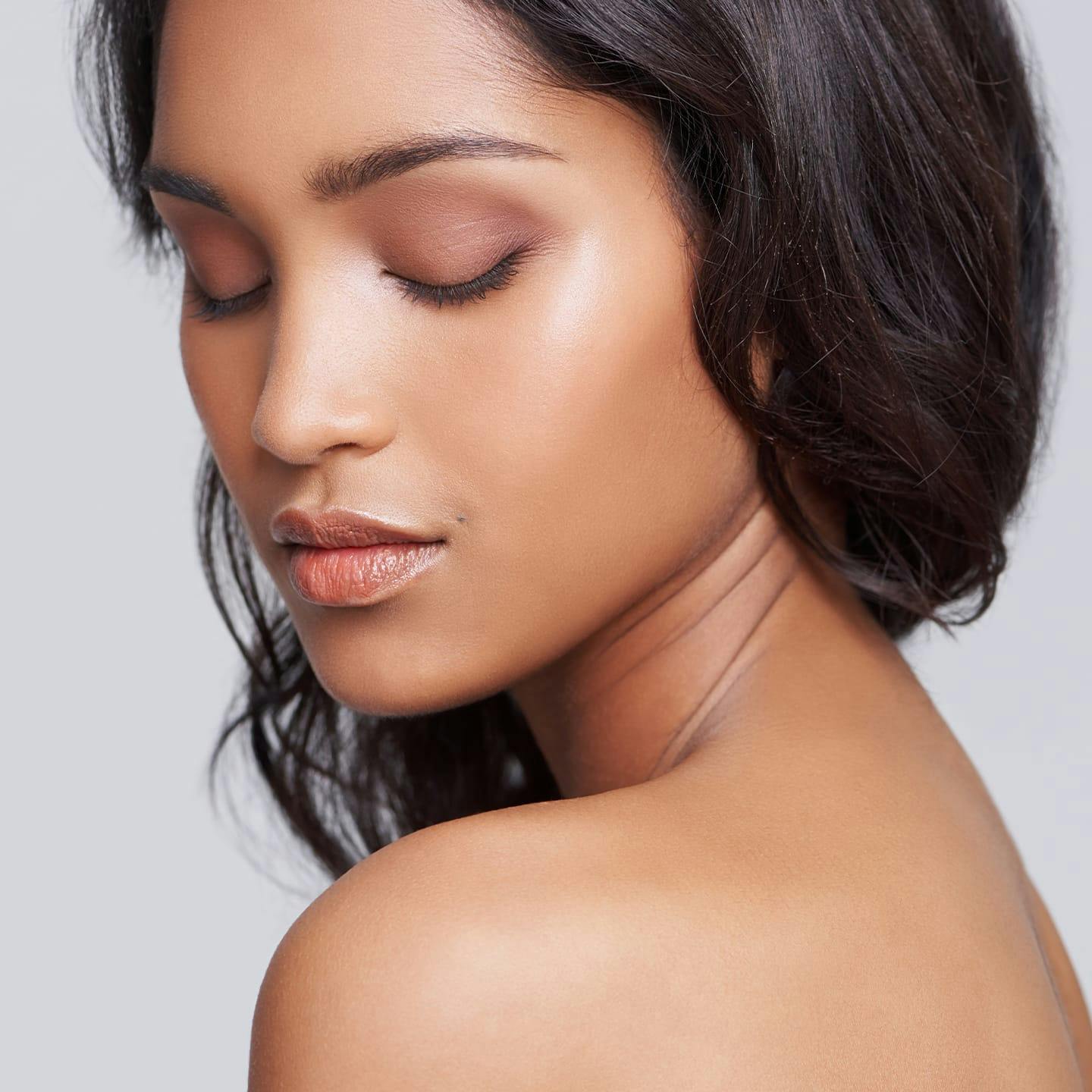 woman looking down and over her shoulder