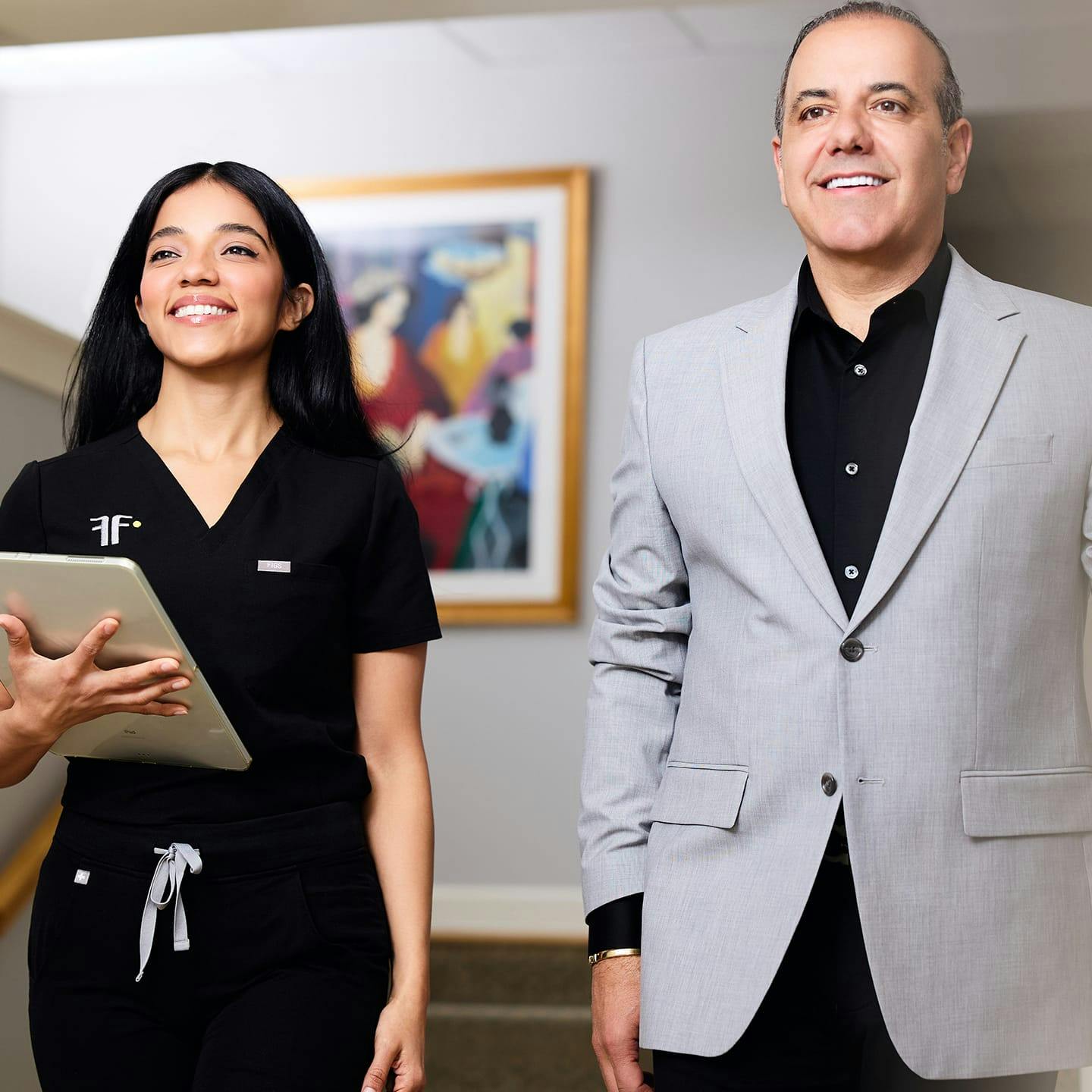 nurse and male patient walking together