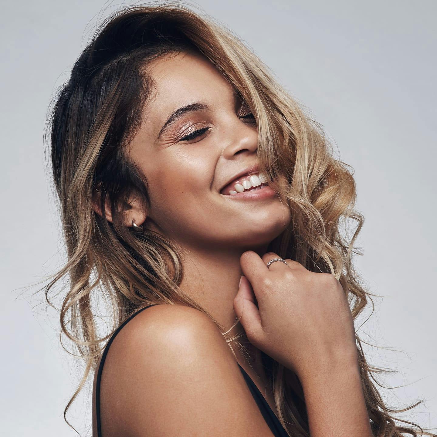 woman smiling with her hair over one side of her face