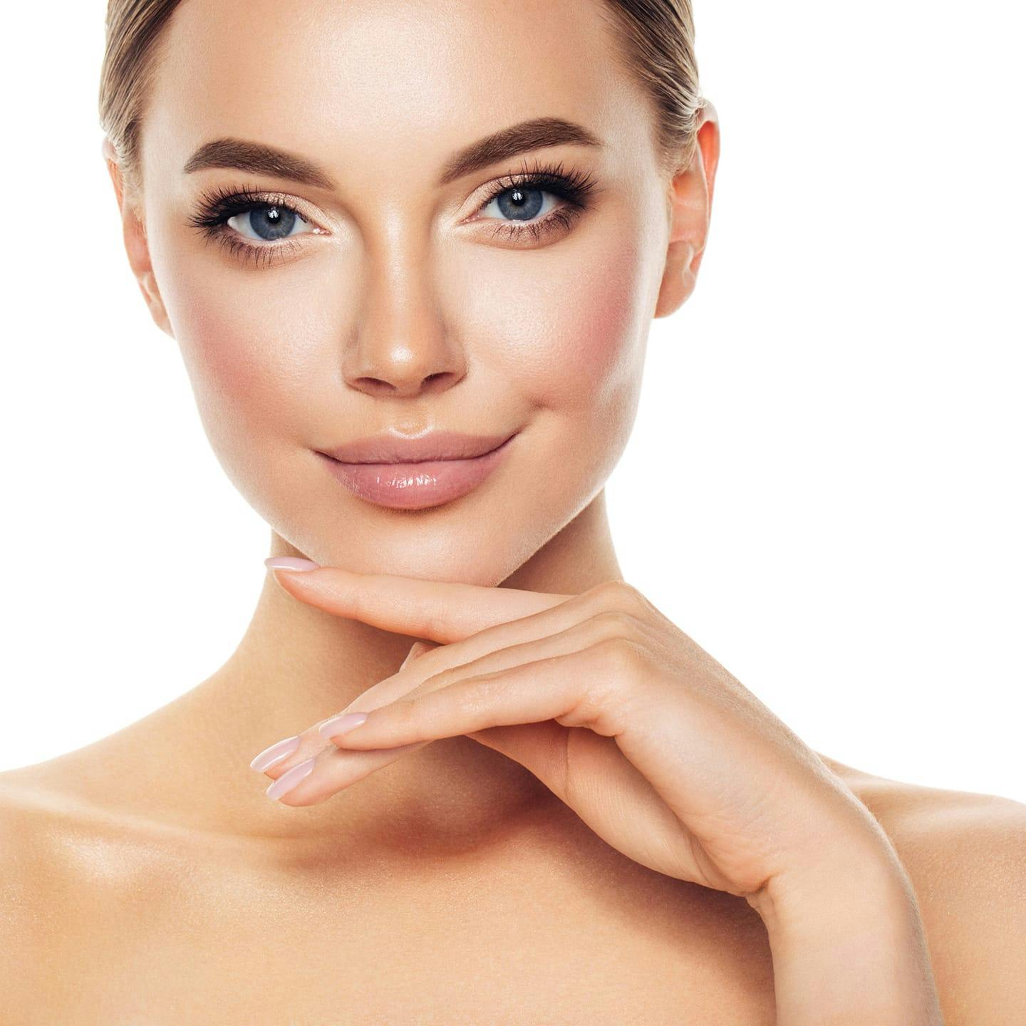 woman smiling with hand near her chin