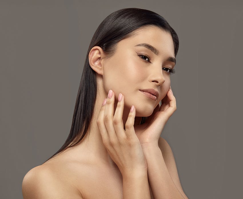 woman touching her jaw area