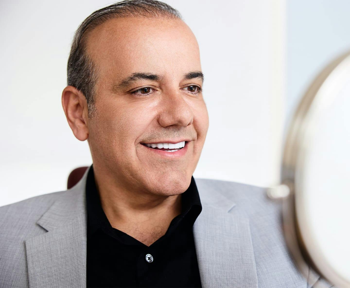 patient smiling wearing black long sleeve shirt