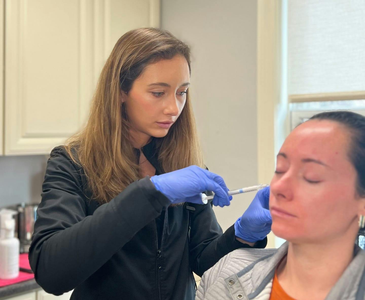 Dr. Fechner pointing to patient's face with a small stick