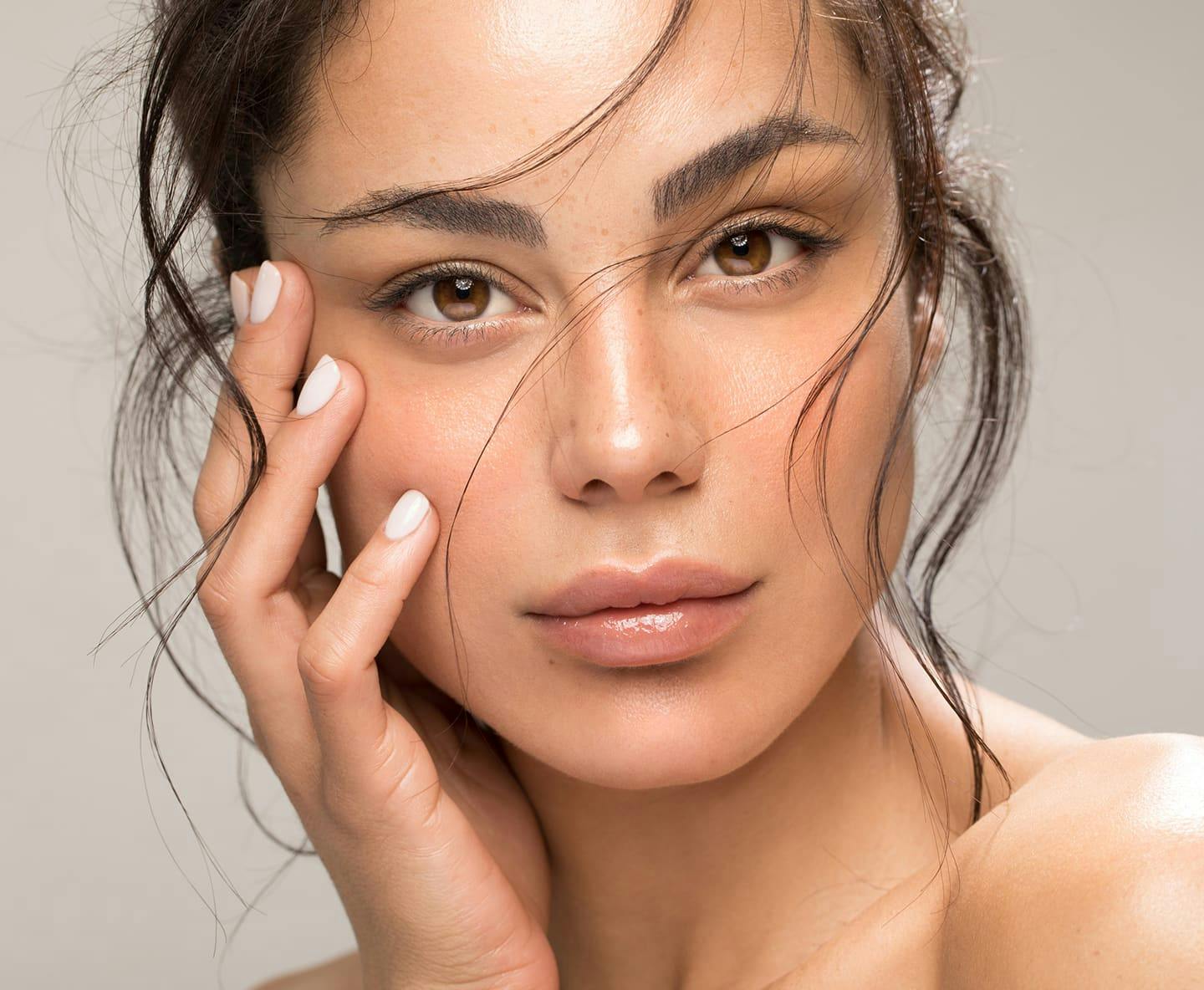 older male patient smiling and handing ipad over to receptionist