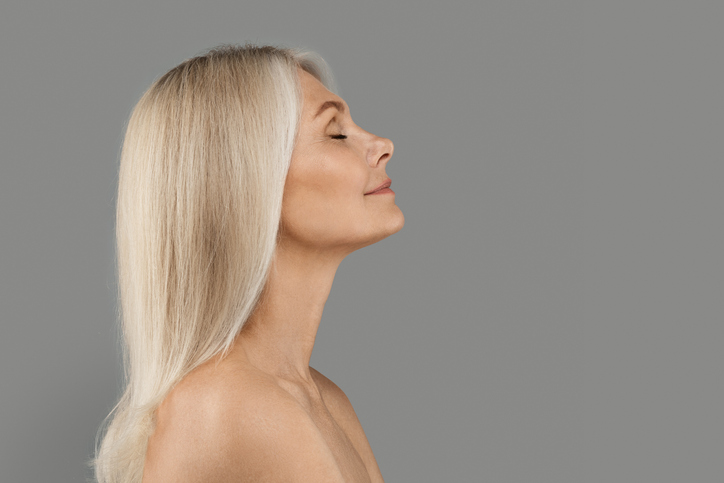 Woman with long blonde hair shown in profile with her eyes closed.