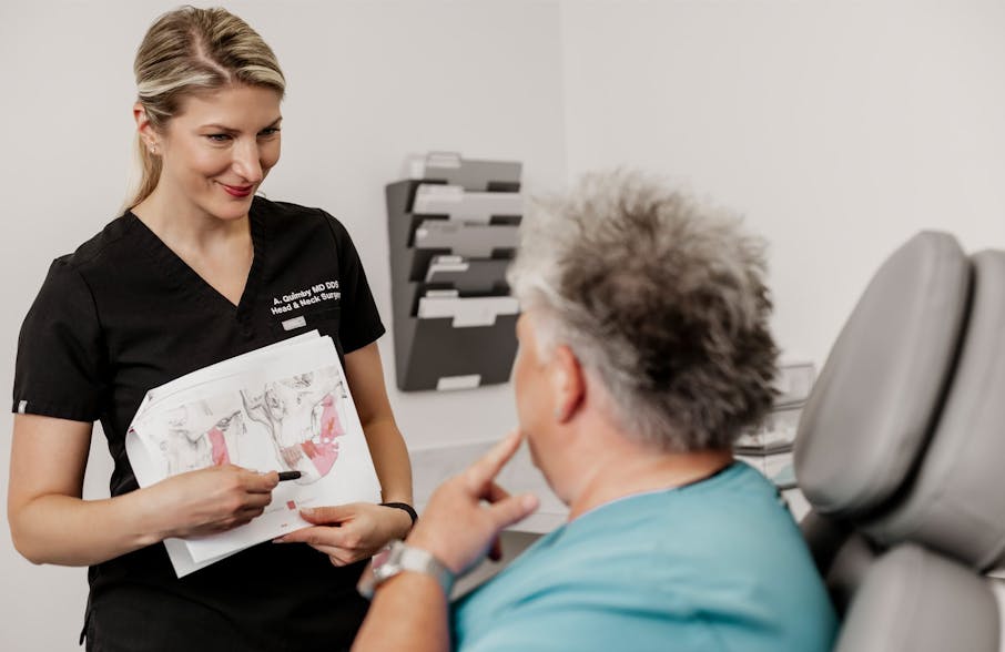 Dr. Quimby showing client a graft of a jaw