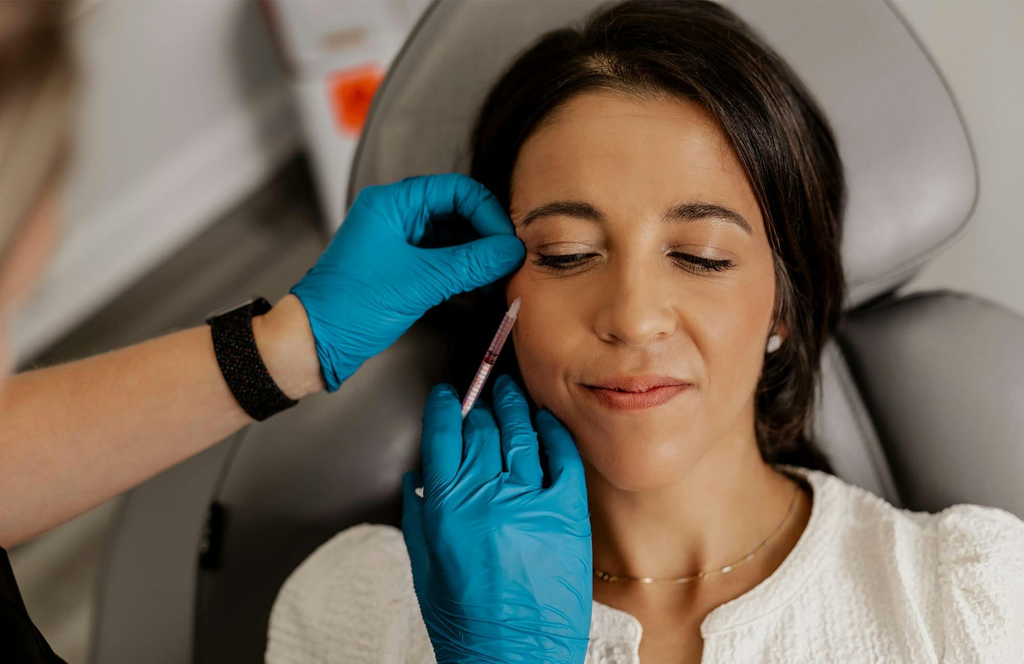 client getting injection in her under eyes