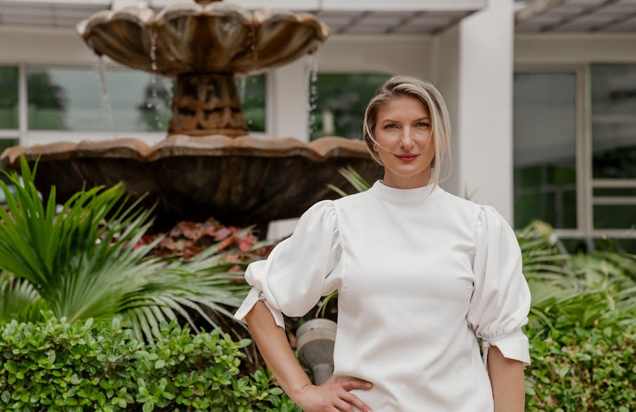Dr. Quimby with hand on her hip in front of fountain