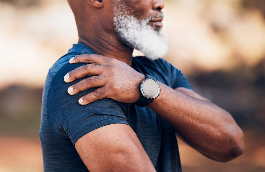 man touching his shoulder