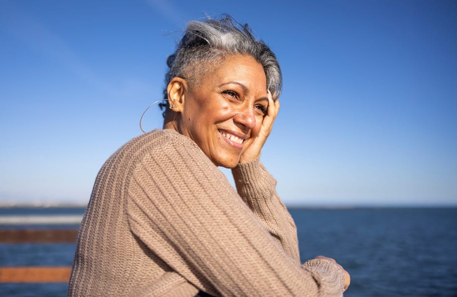 woman leaning on railing with hand on her cheek