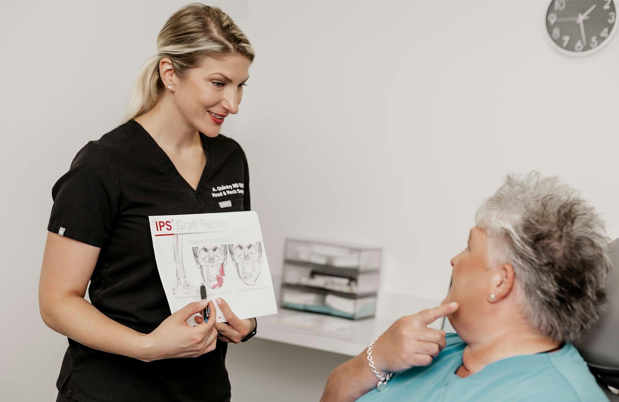 Dr. Quimby showing client a jaw graft