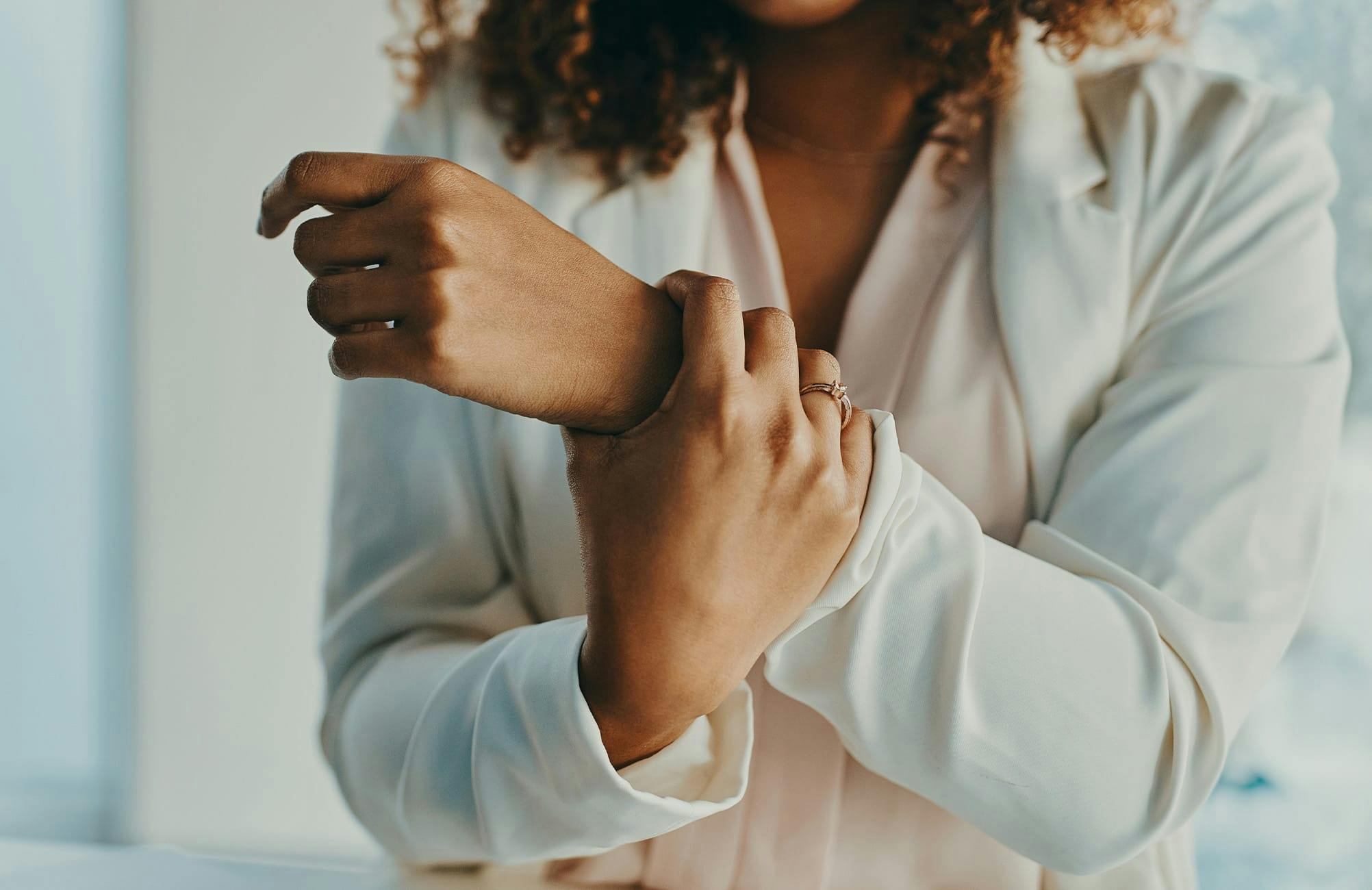 woman grabbing her own wrist