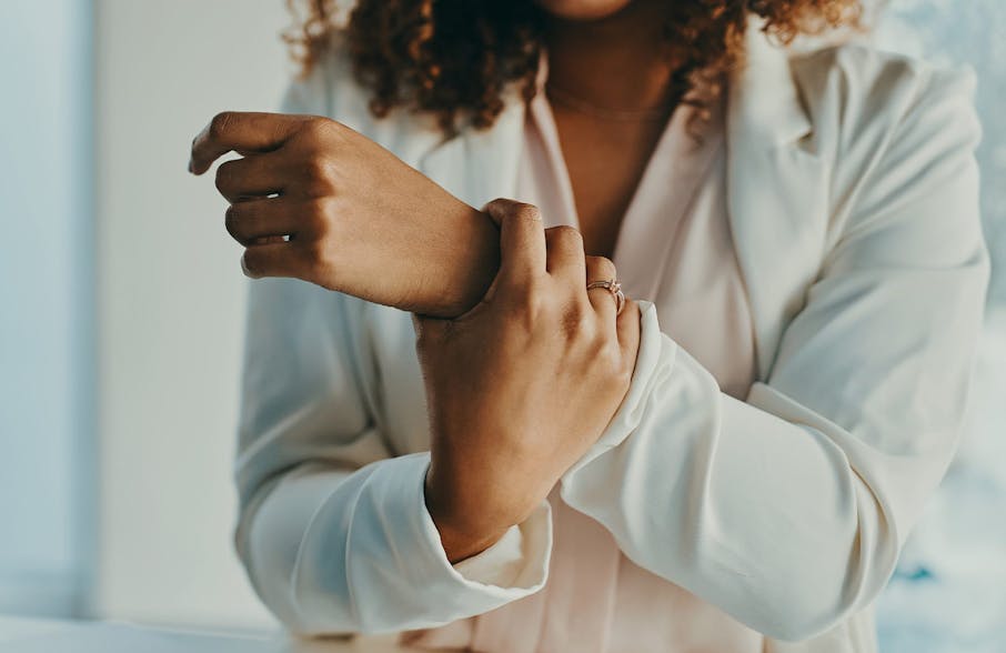 woman grabbing her own wrist