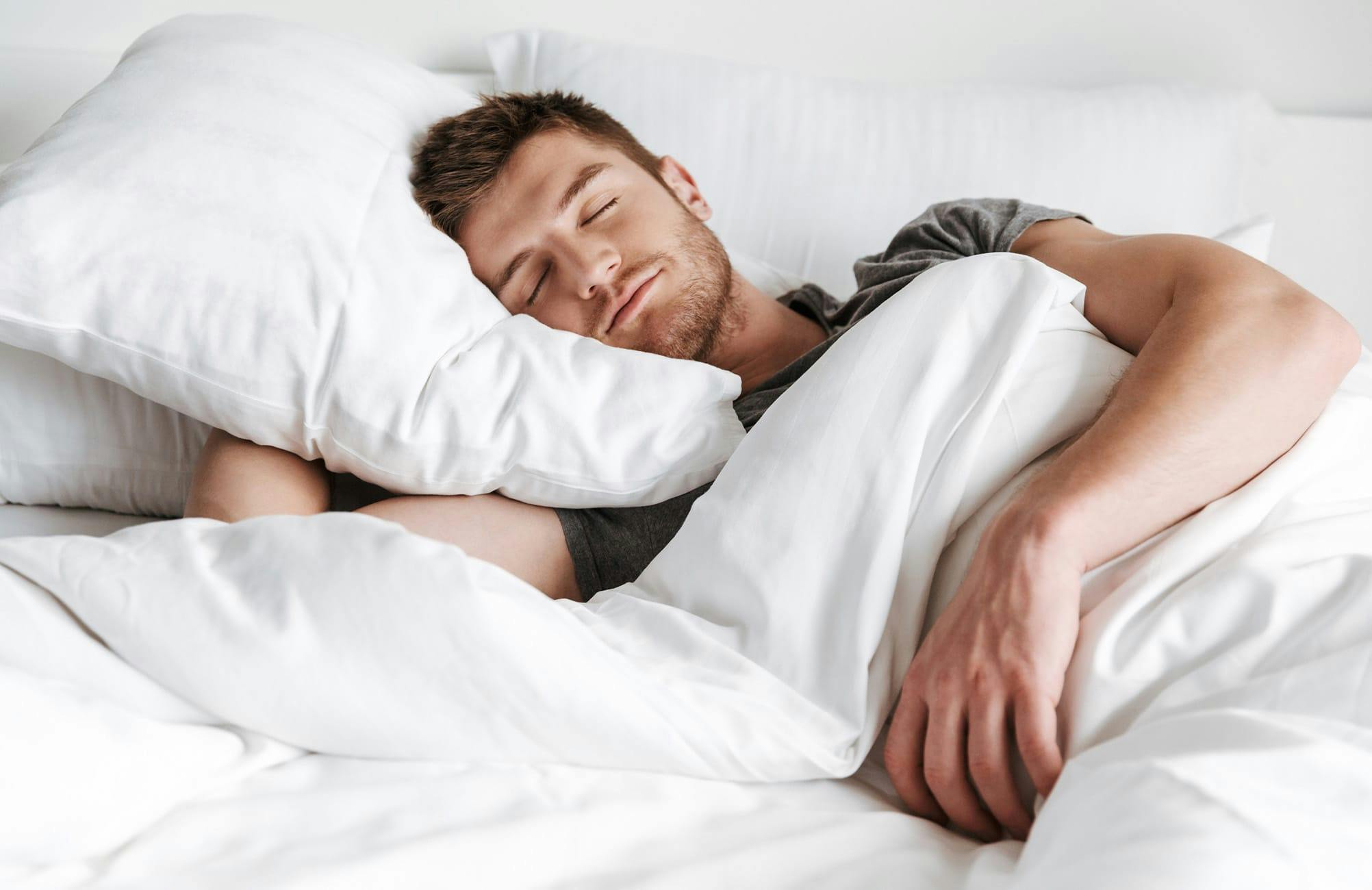 man sleeping in bed