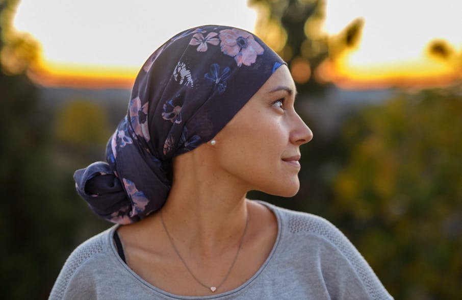 woman with her head wrapped looking to the right