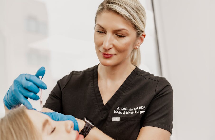 Dr. Quimby injecting into clients forehead