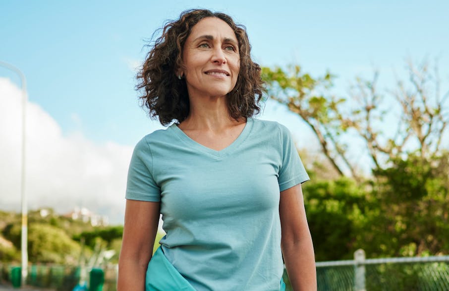 woman with short curly hair in blue shirt