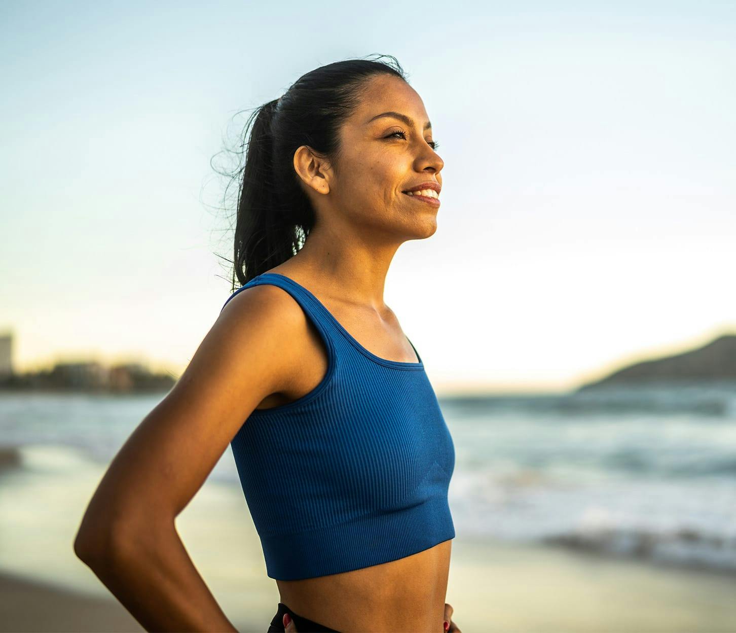 woman in sports bras at beach