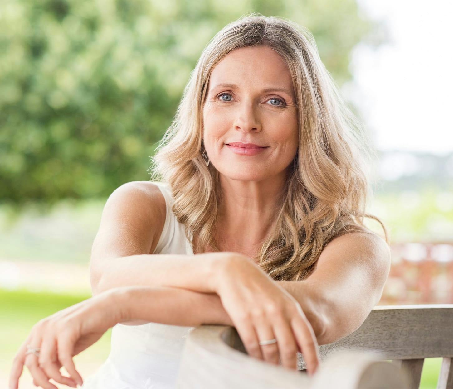 woman sitting on bench with arms crossed