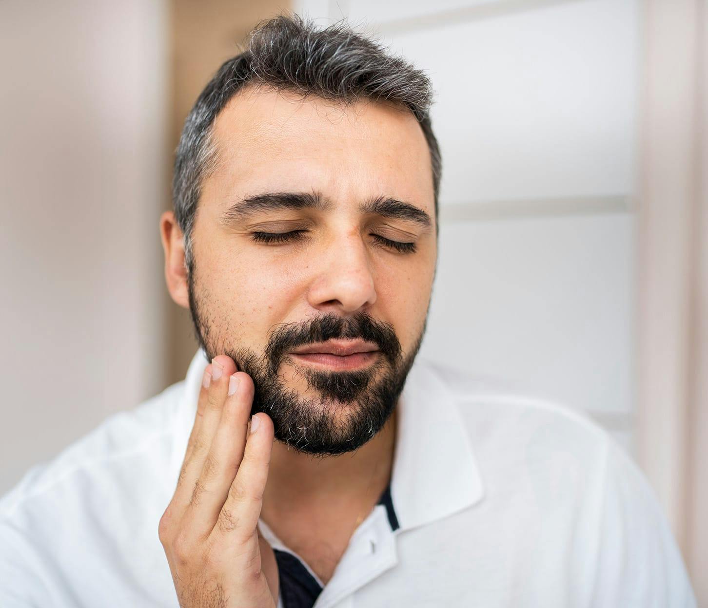 man touching his own beard