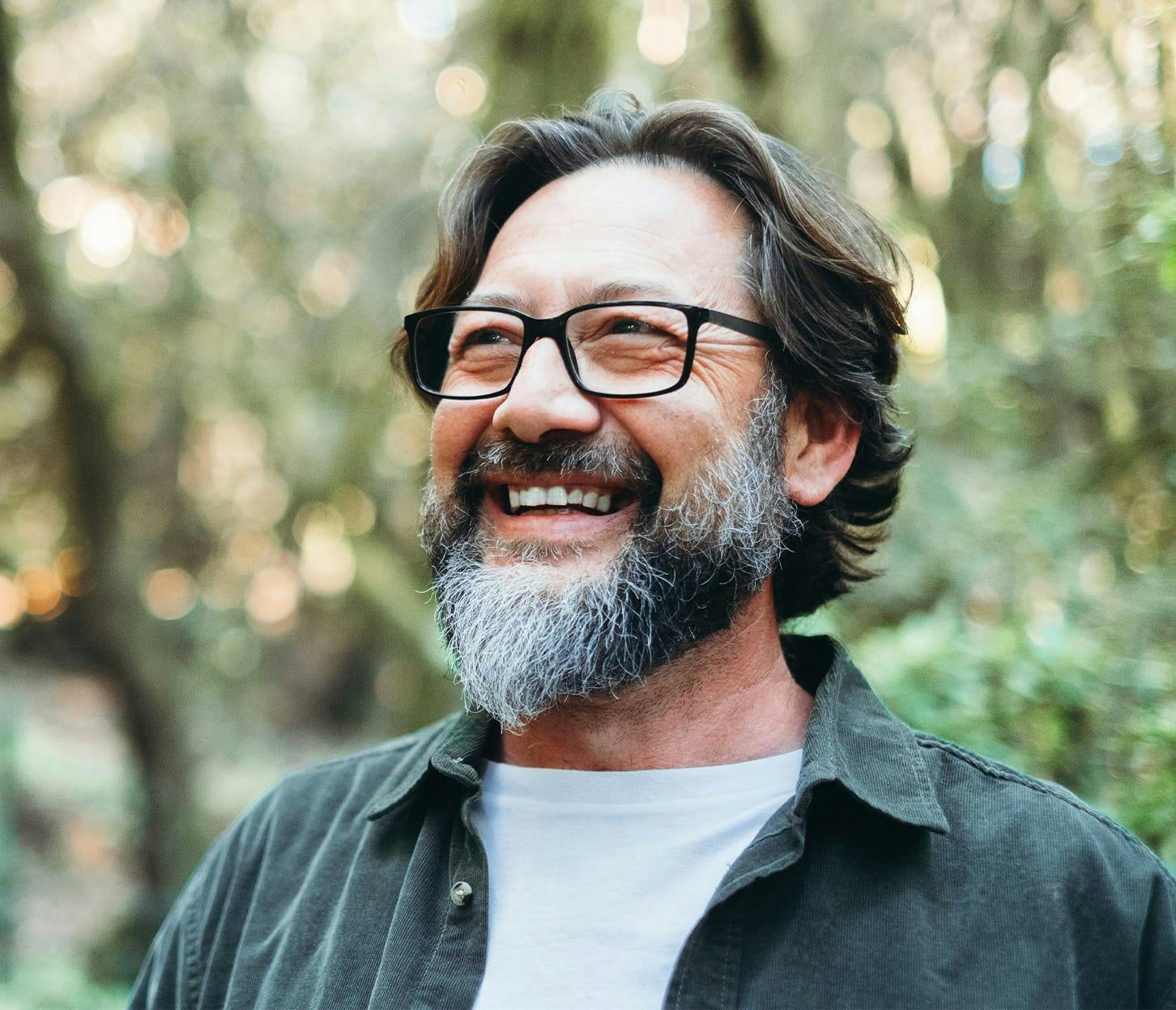 older man smiling with glasses on