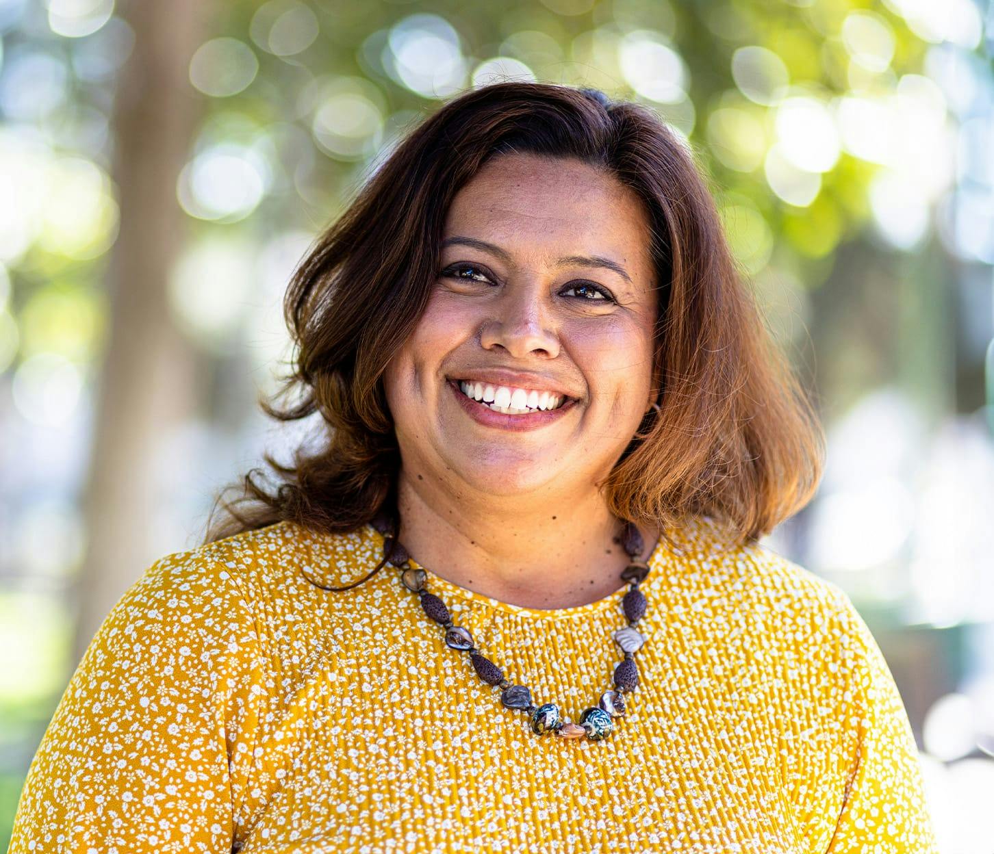 woman in yellow shirt smiling