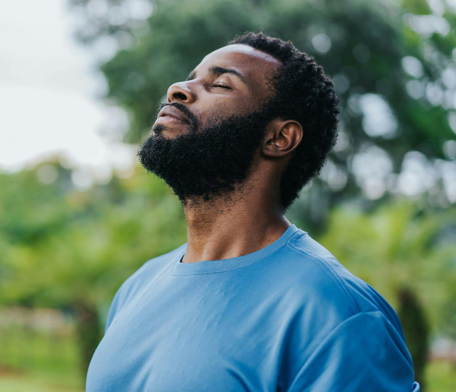 man facing upwards in blue shirt