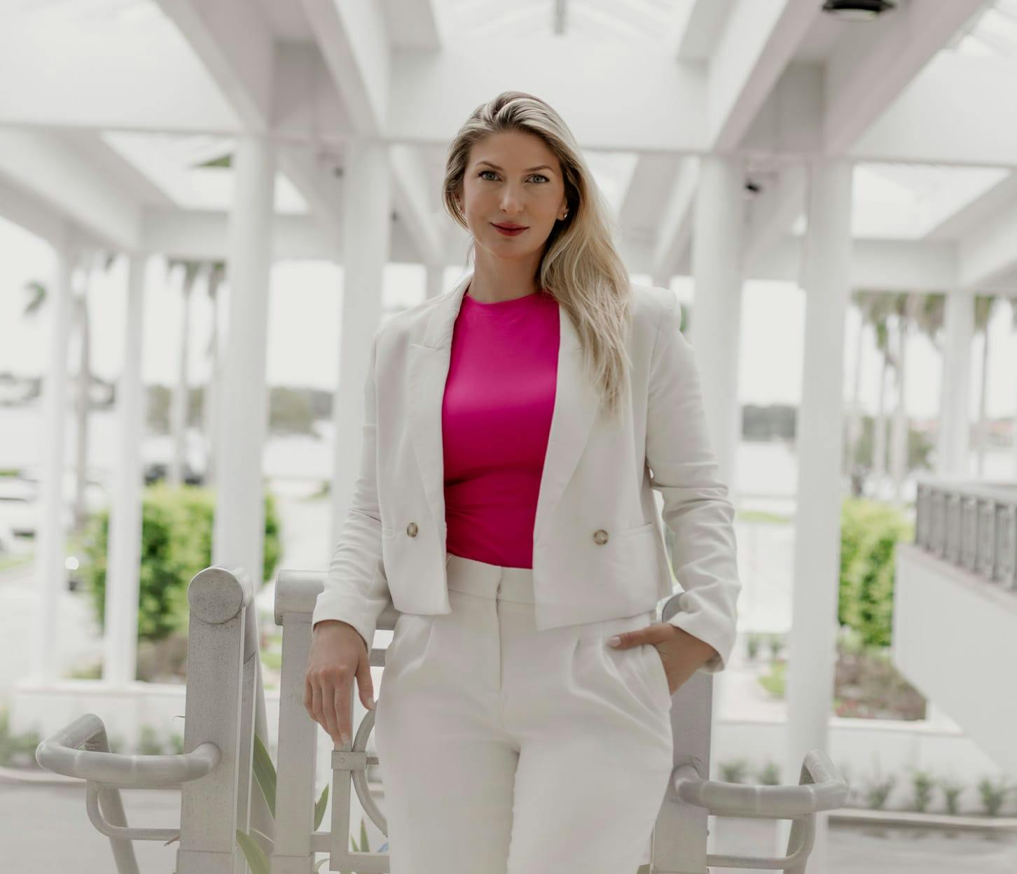 Dr. Anastasiya Quimby in white jacket and bottoms with pink undershirt