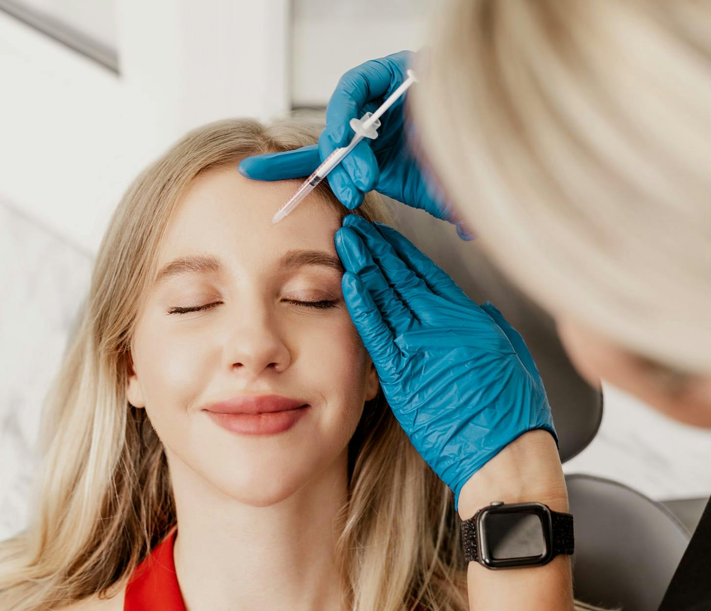 woman getting injection in her forehead