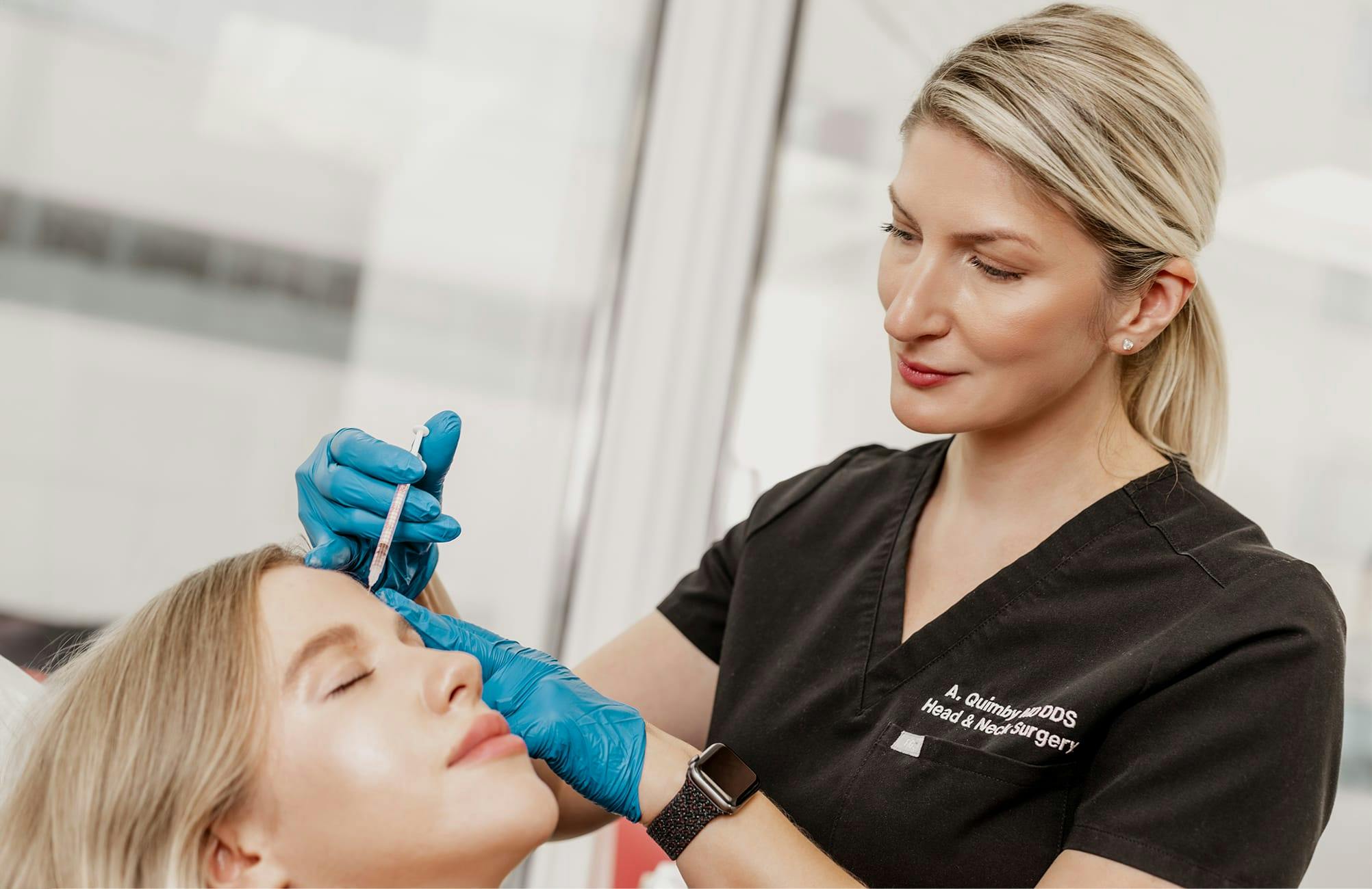 woman getting a face treatment at AQ Surgery