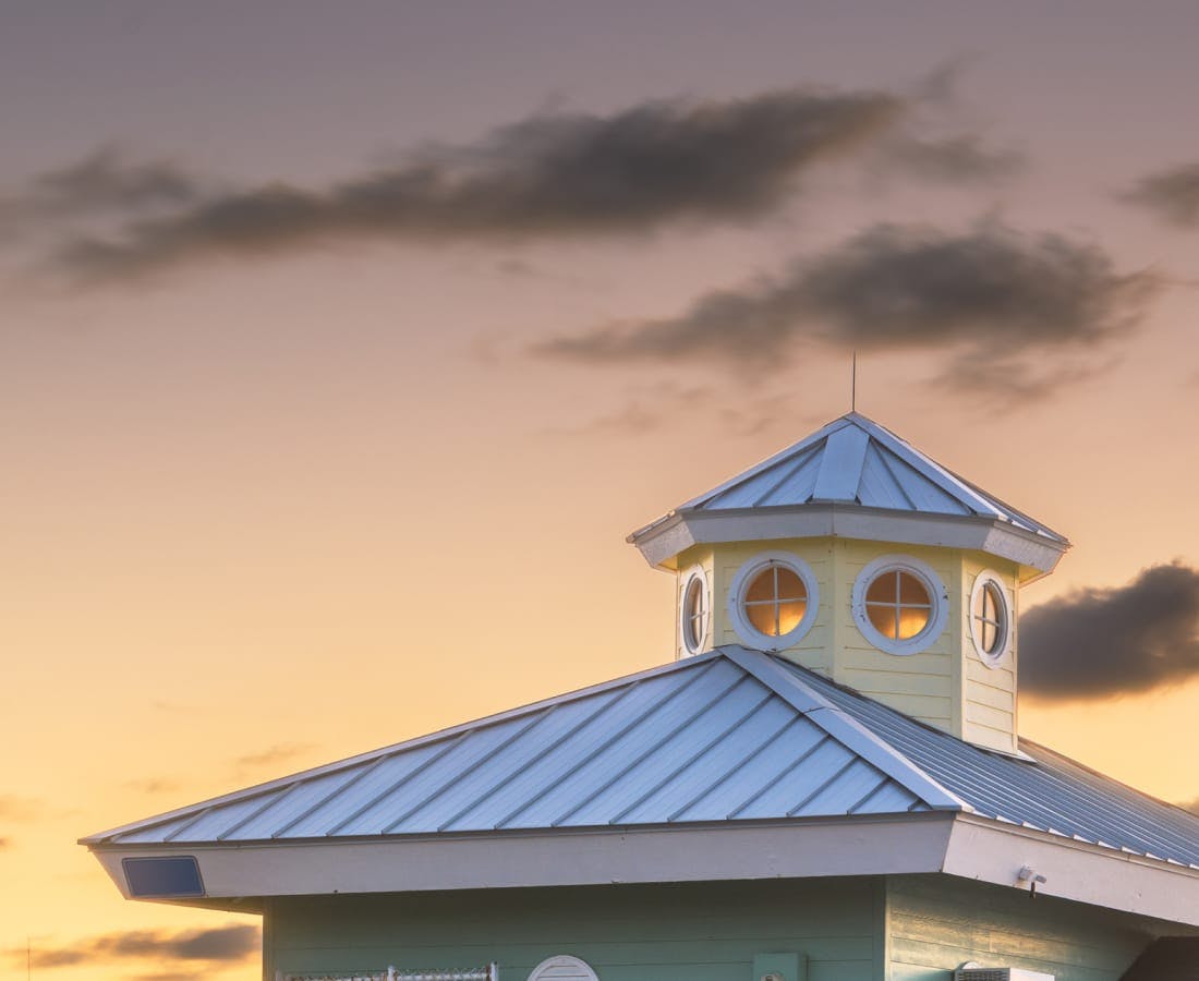 sunset with the top of a building