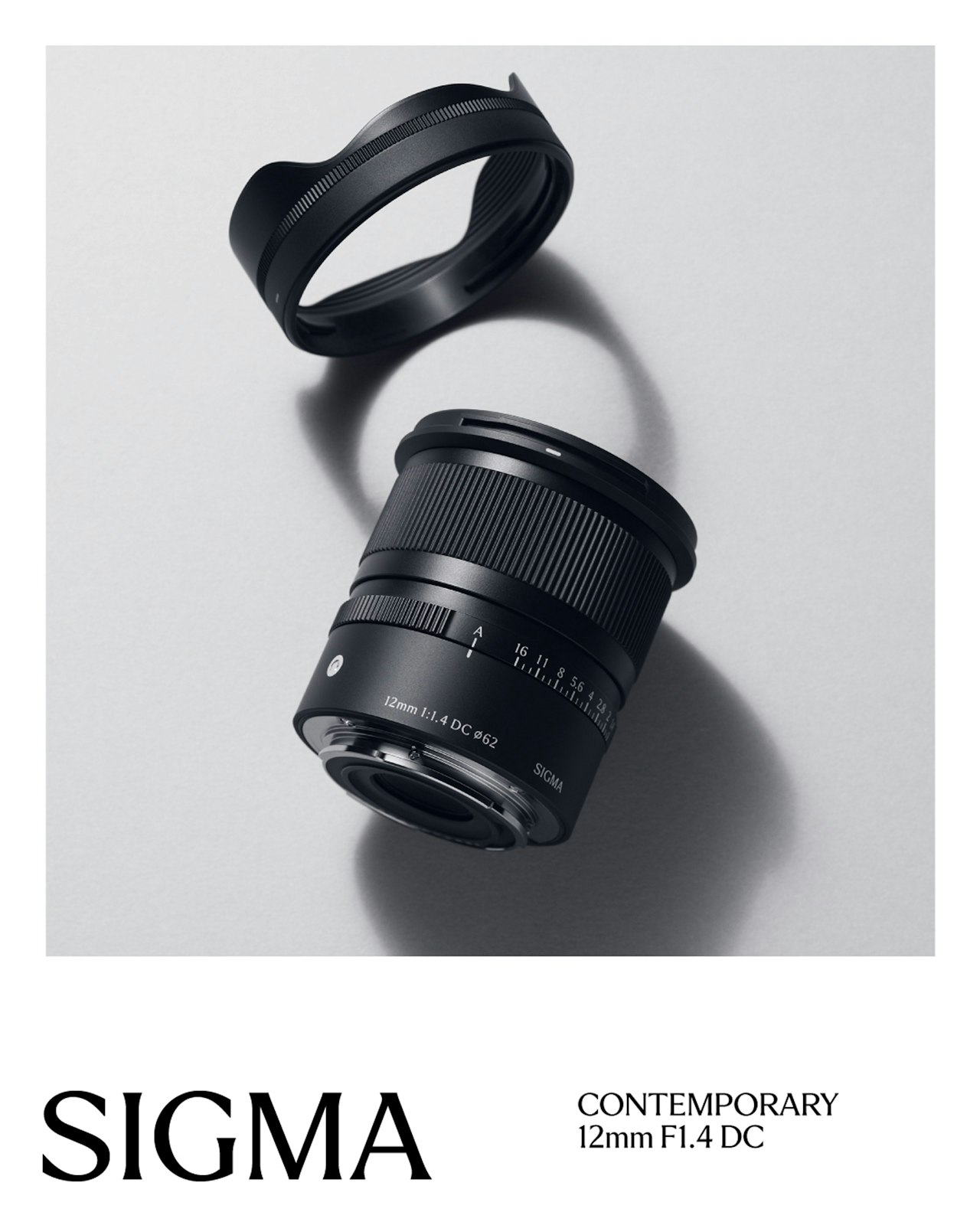 A Sigma 12mm F1.4 DC camera lens with detached lens hood on a light surface.