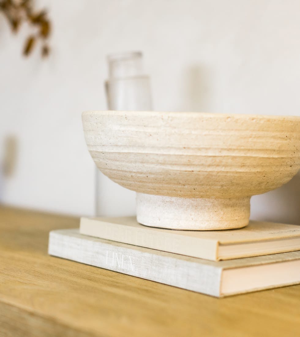 ceramic bowl on top of books