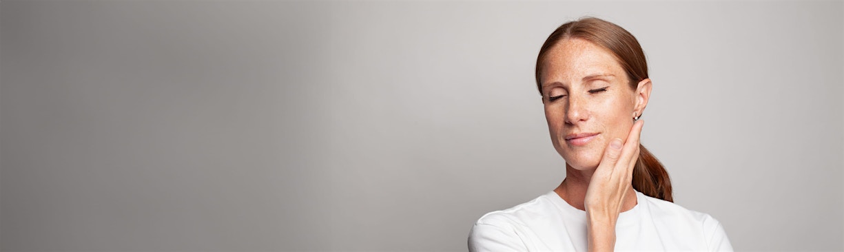 woman resting hand on cheek