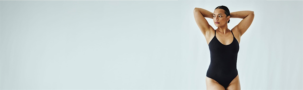 woman posing in black leotard