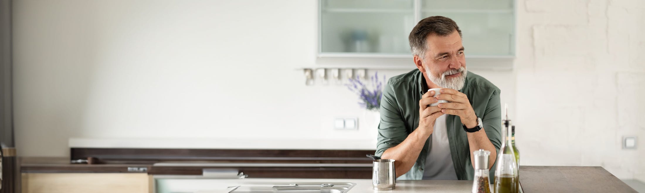 Bearded man holding mug