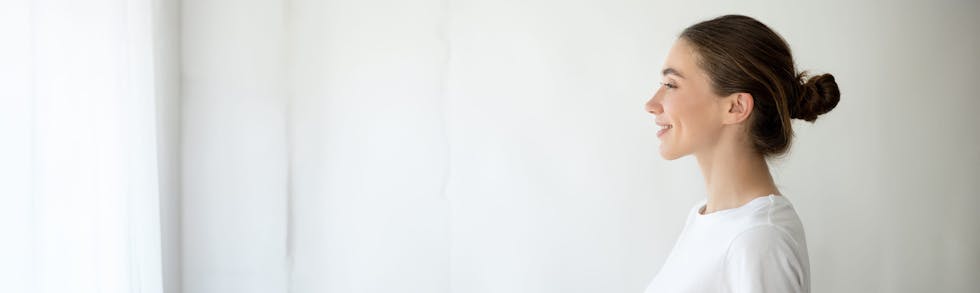 woman smiling and looking at window