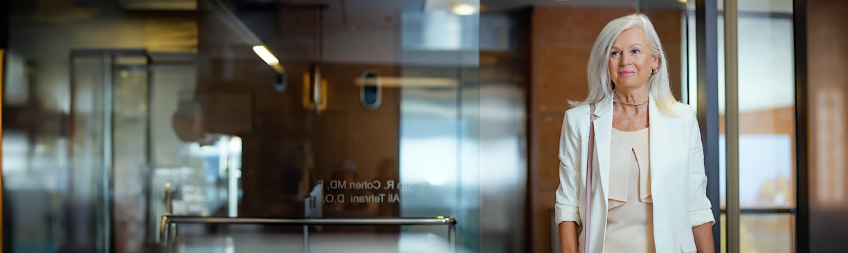 beautiful older woman wearing a white coat