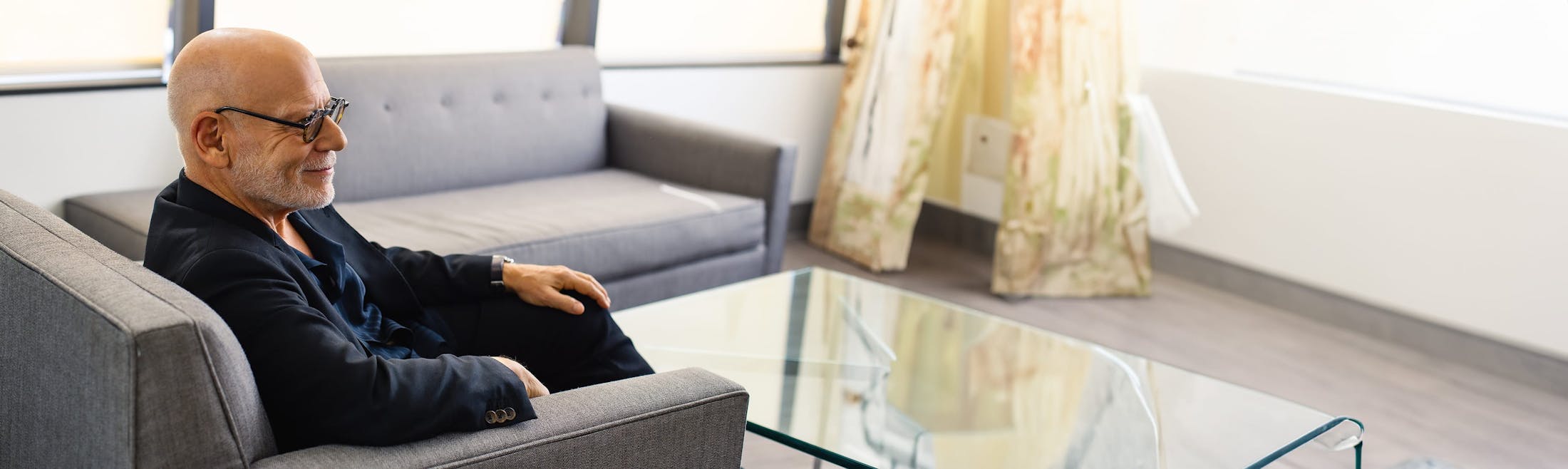 Dr. Cohen sitting on sofa chair