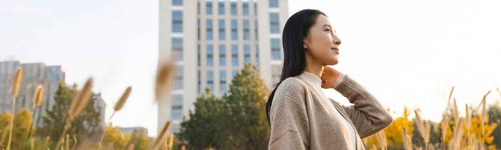 woman in sweater posing outdoors